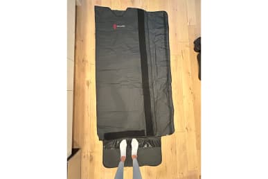 Bon Charge Infrared Sauna Blanket laid flat on the floor with tester's feet