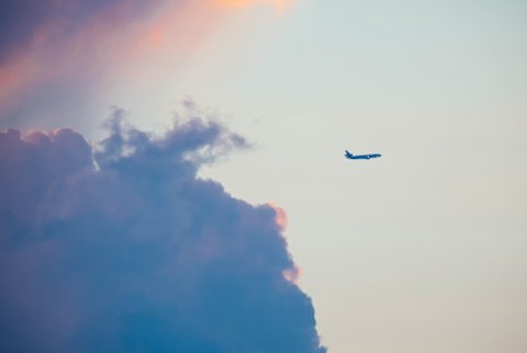 airplane flying in cotton candy colored sky airplane flying in cotton candy colored sky