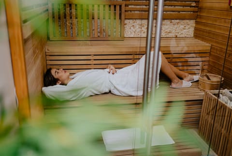 woman laying down in sauna woman laying down in sauna